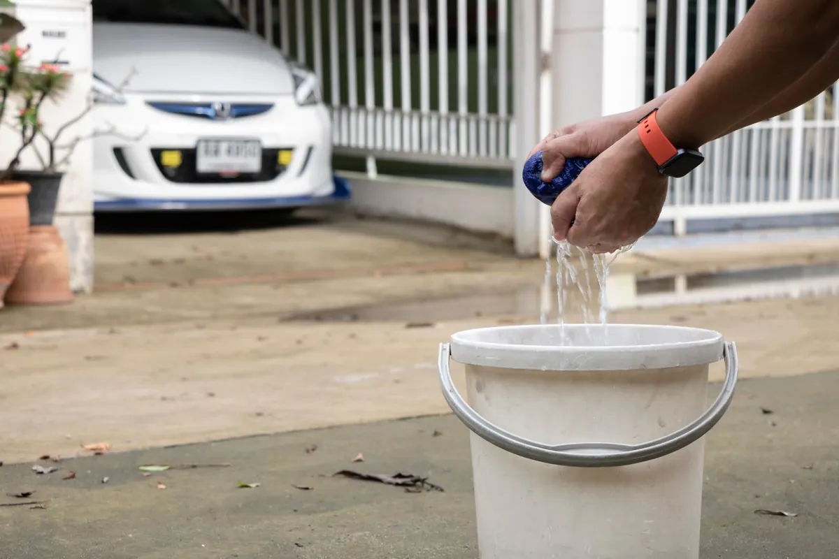 Filling a bucket with water