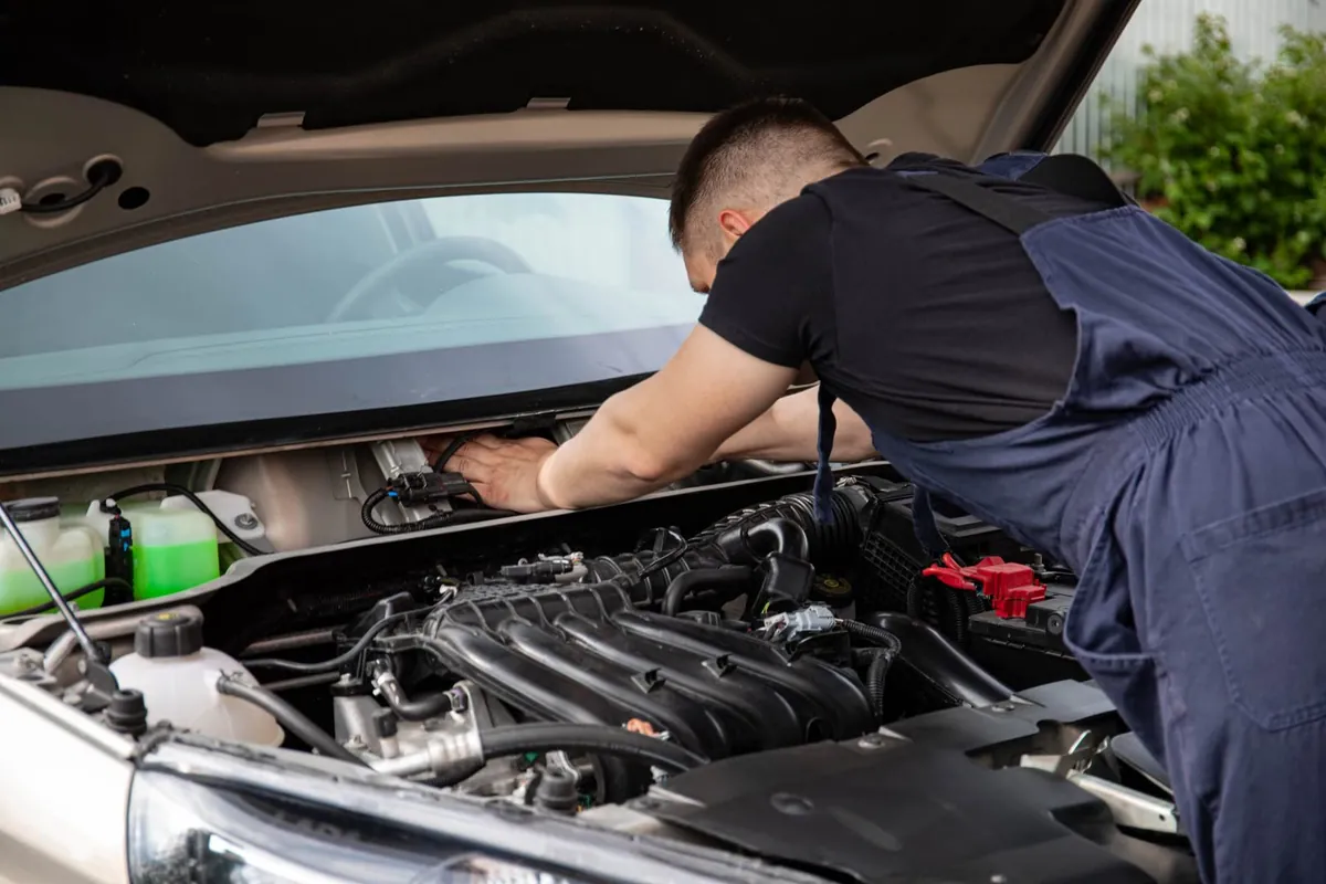 Working under the hood of a car