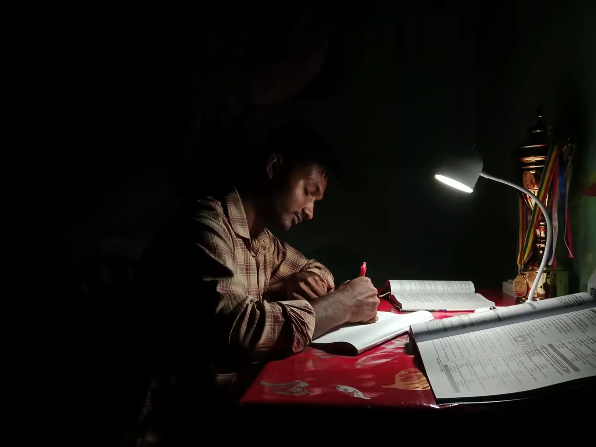 Studying late at night under a desk lamp